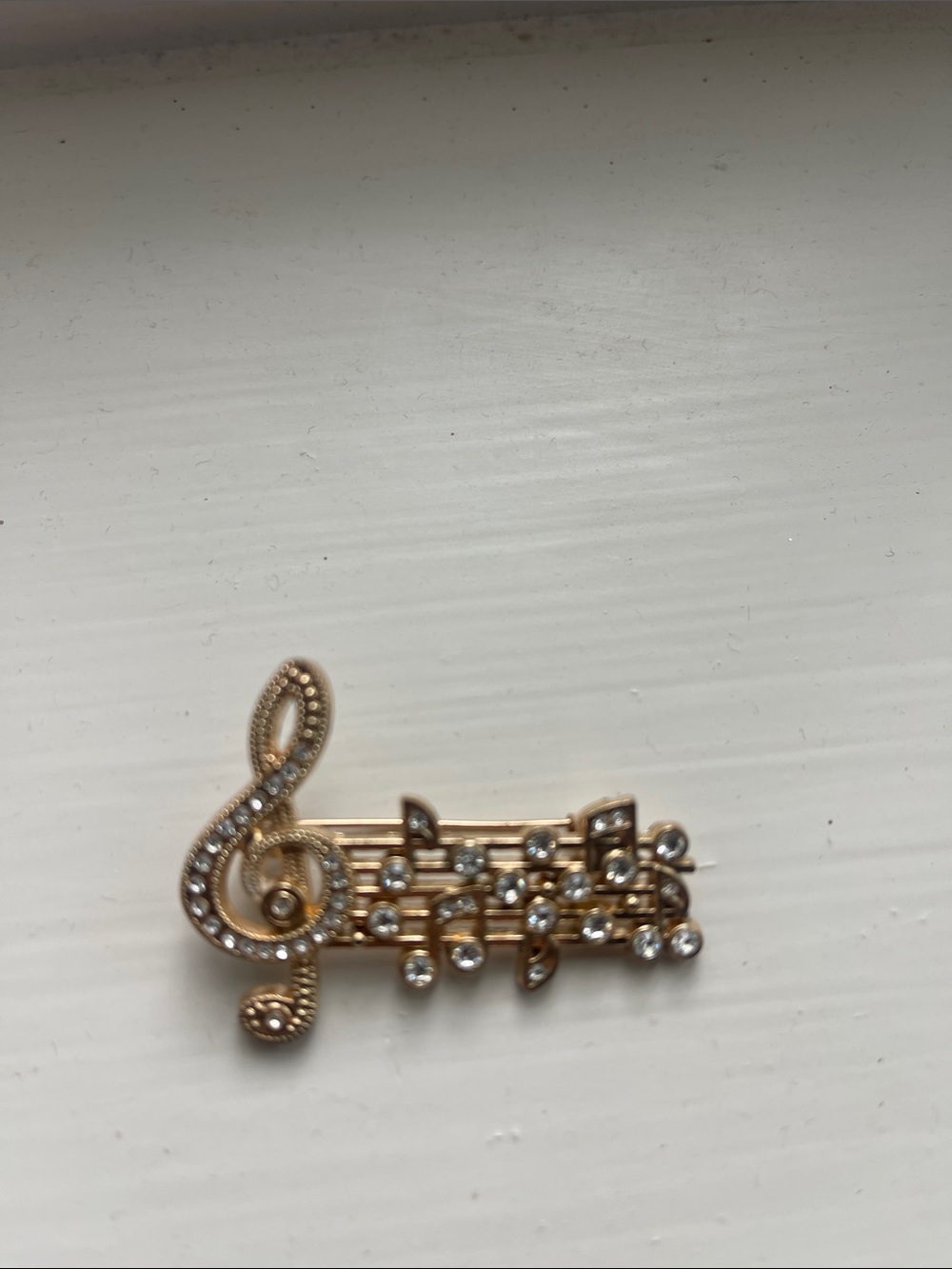 Gold-tone Musical Treble Clef Brooch with Rhinestones